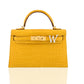 Yellow crocodile-patterned handbag with a gold clasp and white letter 'W' on a white background, collection-preview