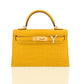 Yellow and beige handbag with a gold clasp on a white background, collection-preview