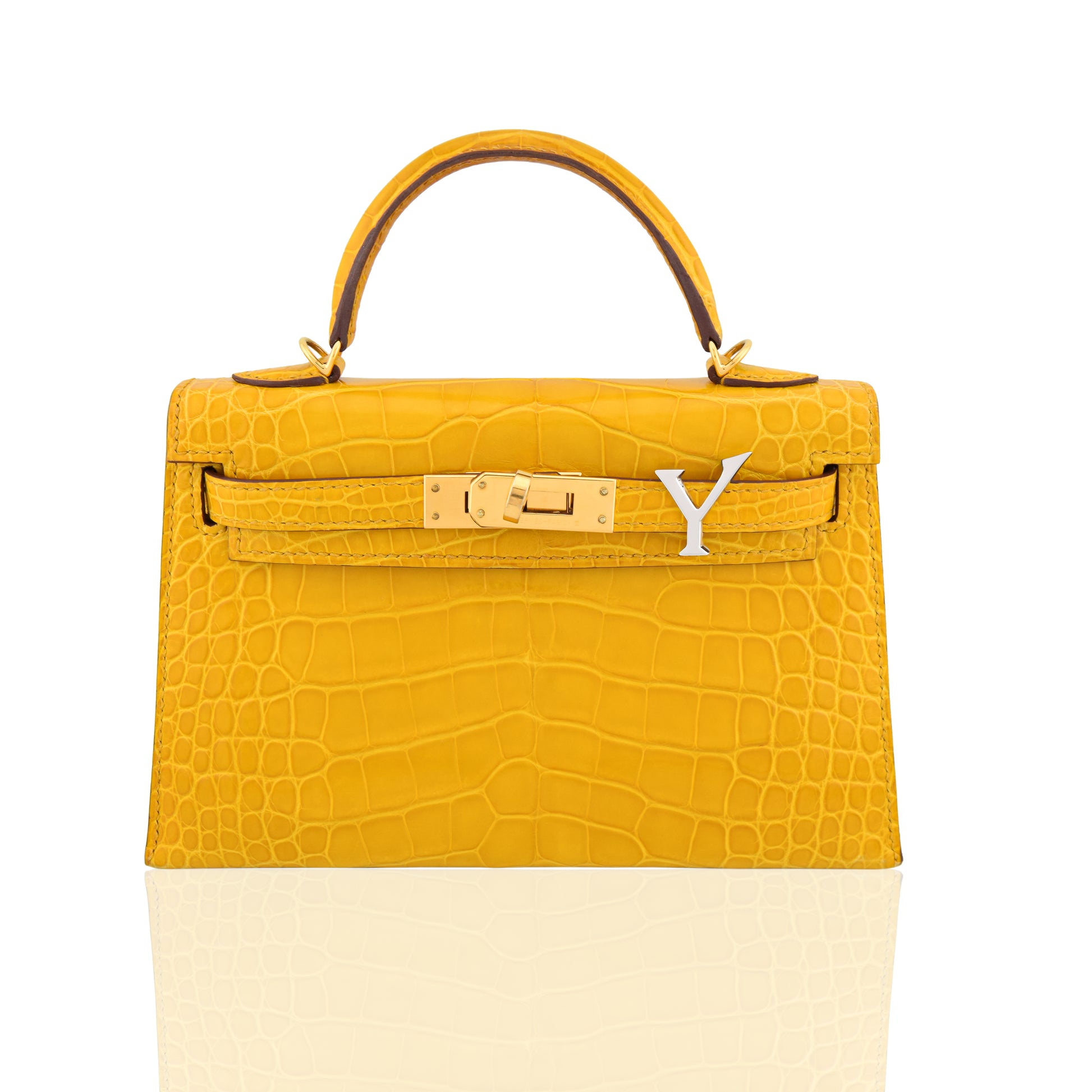 Yellow and beige handbag with a gold clasp on a white background, collection-preview