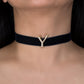 Black choker necklace with a gold 'Y' pendant on a person's neck.
