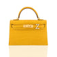 Yellow crocodile skin handbag with gold hardware on a white background, collection-preview