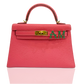Pink handbag with gold clasp and green letters on a white background, collection-preview