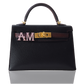 Black handbag with gold hardware and a decorative band on a white , collection-previewbackground