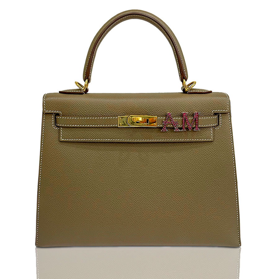Beige handbag with gold hardware and a visible brand logo on a white background, collection-preview
