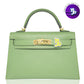 Green handbag with gold hardware on a white background, collection-preview