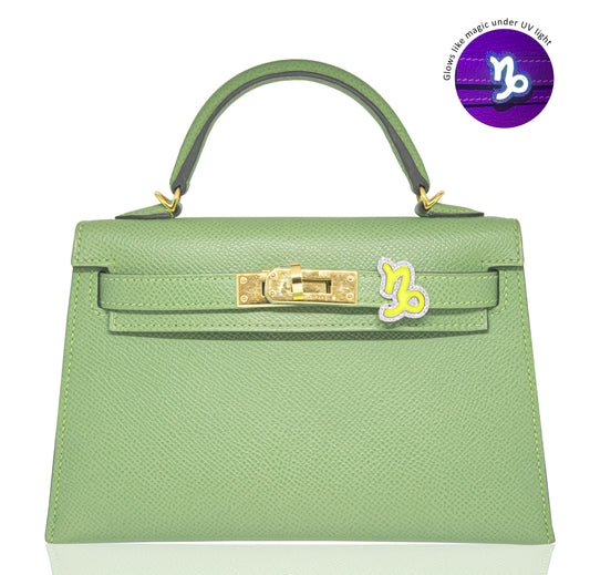 Green handbag with gold hardware on a white background, collection-preview