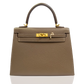 Brown handbag with gold hardware on a white background, collection-preview